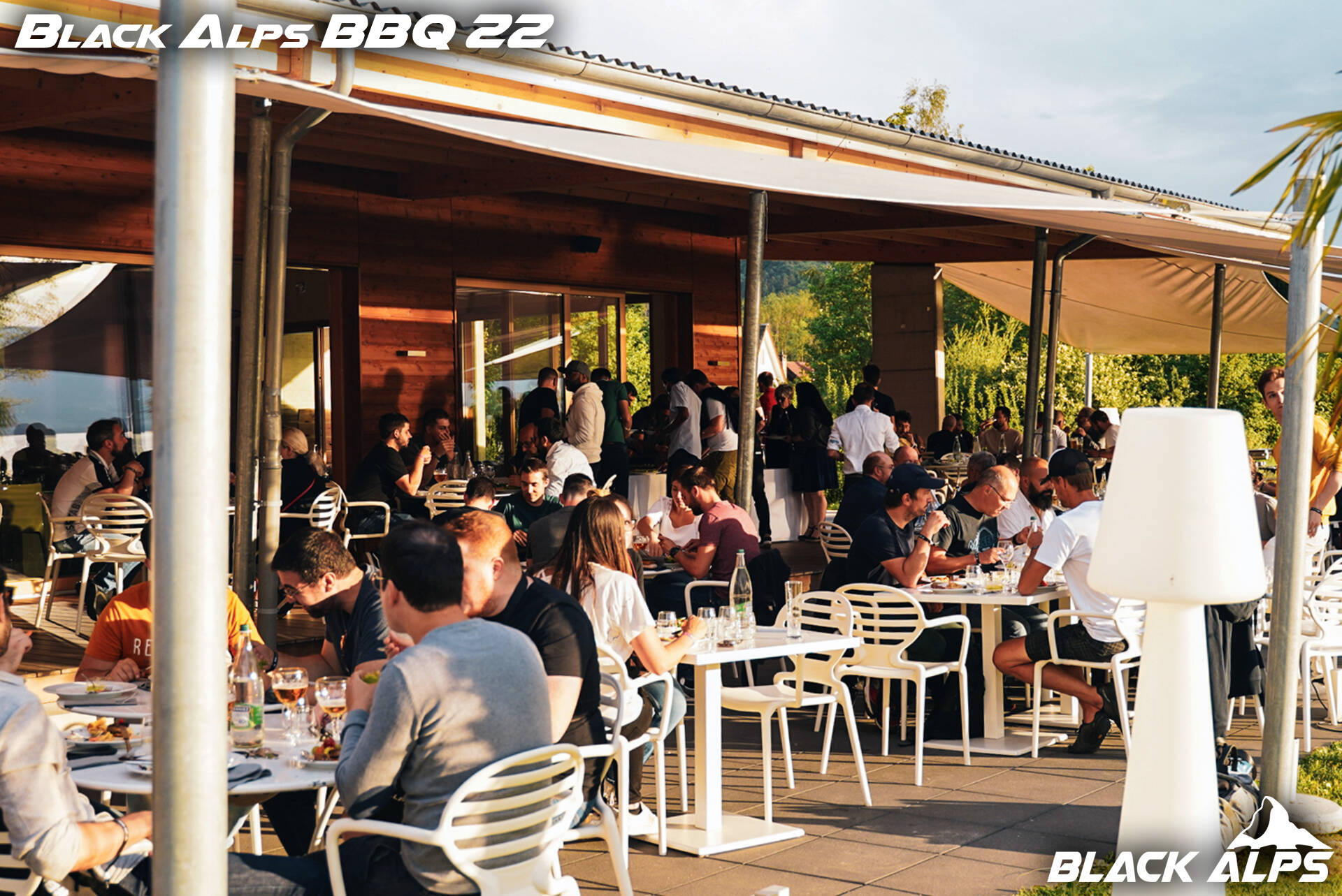 Guests socializing at Black Alps BBQ garden event
