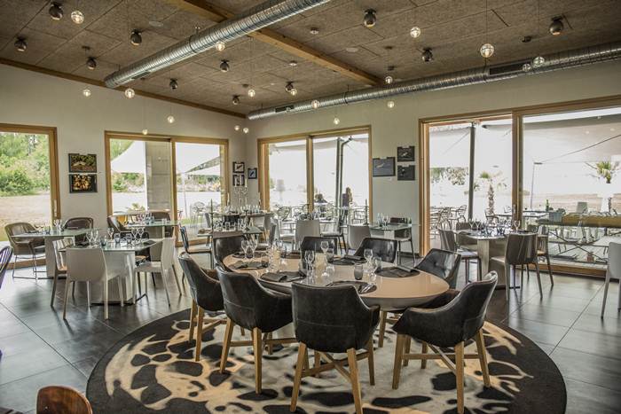 Dining setup at Restaurant La Sarcelle with a lake view